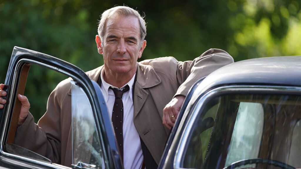 Robson Green as Geordie Keating standing beside car in Grantchester Season 8