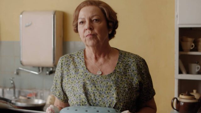 Tessa Peake-Jones as Mrs. C. standing in a kitchen in Grantchester Season 8